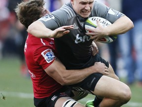 Crusaders Jack Goodhue is tackled by Crusaders Kwagga Smith during the Super Rugby final between South Africa's Lions and New Zealand's Crusaders, at Ellis Park stadium in Johannesburg, Saturday, Aug. 5, 2017. (AP Photo/Phil Magakoe)