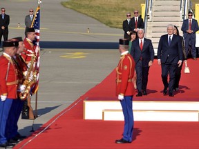 U.S. Vice President Mike Pence, second right, and Montenegro Prime Minister Dusko Markovic, right, attend a welcome ceremony at Golubovci airport, near Podgorica, Montenegro, Tuesday, Aug. 1, 2017. Pence will attend the Adriatic Charter Summit in NATO's newest member - Montenegro, on Wednesday. (AP Photo/Risto Bozovic)