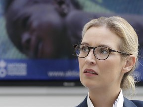 FILE - In this Aug. 21, 2017 file photo, Alice Weidel, co-top candidate of the German AfD (Alternative for Germany) party for the upcoming general elections, sits in front of a news tv screen as she awaits a press conference in Berlin, Germany. Alice Weidel, one of AfD's top leaders, told foreign reporters Monday, Aug. 28, 2017 Donald Trump should devote more energy to governing and less to tweeting, but she insists the U.S. president's performance has no influence on her party's popularity.  (AP Photo/Michael Sohn,file)