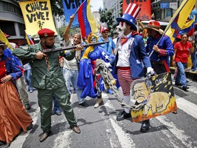 Government supporters perform a parody involving a Venezuelan militia up against Uncle Sam, a personification of the U.S government, during an anti-imperialist march to denounce Trump's talk of a "military option" for resolving the country's political crisis, in Caracas, Venezuela, Monday, Aug. 14, 2017. (AP Photo/Ariana Cubillos)