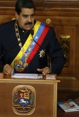 Venezuela's President Nicolas Maduro addresses Constitutional Assembly members at the National Assembly building in Caracas, Venezuela, Thursday, Aug. 10, 2017, as a book at his right shows the face of his late predecessor Hugo Chavez, which outlines Chavez's project coined "Plan de Patria," or "Plan Homeland." Maduro pushed for the creation of the constitutional assembly to rewrite the constitution.  (AP Photo/Ariana Cubillos)