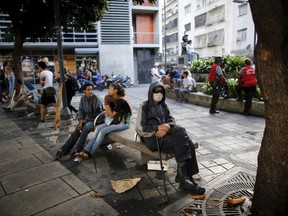 An anti-government demonstrators rest at a square in Chacao, Caracas, Venezuela, Sunday, July 30, 2017. Venezuelans appear to be abstaining in massive numbers in a show of silent protest against a vote to select a constitutional assembly giving the government virtually unlimited powers. Across the capital on Sunday, dozens of polling places were empty or had a few dozens or hundreds of people outside, orders of magnitude less than the turnout in recent elections. (AP Photo/Ariana Cubillos)