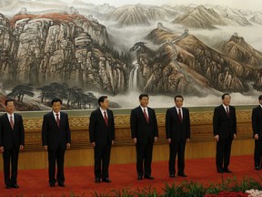 In this file photo taken Thursday, Nov. 15, 2012, then newly named members of the Politburo Standing Committee, from left, Zhang Gaoli, Liu Yunshan, Zhang Dejiang, Xi Jinping, Li Keqiang, Yu Zhengsheng and Wang Qishan stand in Beijing's Great Hall of the People following the end of the 18th Communist Party Congress. As they do each summer, China's leaders have headed to the beach for bit of relaxation and informal meetings on matters both trivial and weighty. This year's retreat will likely be a final breather ahead of a key party Communist Party congress expected in the fall at which President Xi Jinping will launch his second five-year term as party chief and cement his status as China's most powerful leader in decades. (AP Photo/Vincent Yu, File)