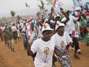 Supporters of Rwanda's President Paul Kagame, center, attend an election campaign rally on the hills overlooking Kigali, Rwanda, Wednesday Aug. 2, 2017. Rwanda's longtime president has already claimed victory in Friday's election. In this strictly run country, Paul Kagame is praised for bringing economic development but criticized for stifling opposition _ and now the constitution allows him to stay in power until 2034. (AP Photo/Jerome Delay)