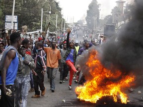 Supporters of opposition leader Raila Odinga make fire barricades to block the road at Kibera slum of Nairobi, Kenya, Saturday, Aug. 12, 2017.