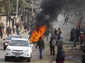 Supporters of Kenyan opposition leader and presidential candidate Raila Odinga demonstrate in the Kibera area blocking roads with burning tires in Nairobi, Kenya. Wednesday Aug. 9, 2017. Kenyan police opened fire Wednesday to disperse rioters in several areas after presidential challenger Raila Odinga alleged election fraud, saying hackers. (AP Photo/Khalil Senosi)