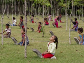 FILE - In this Sept. 21, 2011 file photo, school children take part in an outdoor class that teaches them about native Amazon trees in an environmental park in Paragominas, northern state of Para, Brazil. Environmentalists are condemning the Wednesday, Aug. 23, 2017 decree by Brazilian President Michel Temer allowing mining in the heart of the Amazon. The measure strips protection from a national reserve between the northern states of Para and Amapa and clears the way for the private mining sector to explore the forest. (AP Photo/Andre Penner, File)