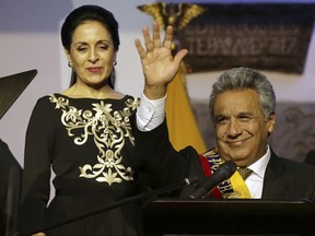 FILE - In this May 24, 2017 file photo, accompanied by his wife Rocio Gonzalez, Ecuador's President Lenin Moreno, greets well wishers, at government palace in Quito, Ecuador. A little more than 70% of Ecuadoreans approve of the job their new president is doing, according to a Cedatos-Gallup poll. (AP Photo/Dolores Ochoa, File)