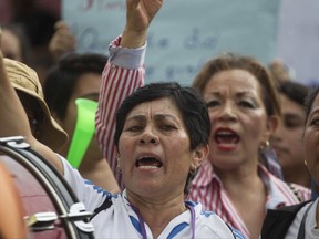 People take part in a demonstration in support of the Commissioner of the United Nations International Commission Against Impunity, Ivan Velasquez, in Guatemala City, Saturday, Aug. 26, 2017. Velasquez and Guatemala's attorney general are calling for the removal of President Jimmy Morales' political immunity to investigate him for illicit electoral financing. (AP Photo/Moises Castillo)