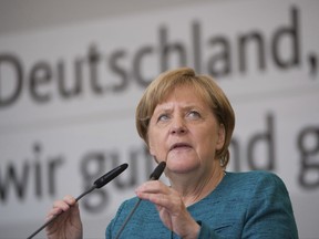 In this Aug. 17, 2017 file photo,  German Chancellor Angela Merkel speaks during an election campaign event in Annaberg-Buchholz, eastern Germany. German Chancellor Angela Merkel on Sunday Aug. 20, 2017 stood by her decision to open Germany's borders to hundreds of thousands of refugees two years ago, a move she has previously defended as a necessary response to a humanitarian emergency. Asked during a pre-election television event with voters whether she would do things differently if faced with the same situation, Merkel said in retrospect, "I still think my decision was right."  (Sebastian Kahnert/dpa via AP)