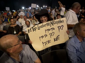 Supporters of Israel's Prime Minister Benjamin Netanyahu attend a Likud Party conference in Tel Aviv, Israel, Wednesday Aug. 9, 2017. At the conference Netanyahu lashed out at the media and his political opponents in an animated speech to hundreds of enthusiastic supporters on Wednesday, seeking to deliver a powerful show of force as he battles a slew of corruption allegations that have threatened to drive him from office. (AP Photo/Oded Balilty)