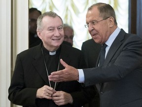 Russian Foreign Minister Sergey Lavrov, right, and Vatican Secretary of State, Cardinal Pietro Parolin enter a hall for talks in Moscow, Russia, Tuesday, Aug. 22, 2017. (AP Photo/Pavel Golovkin)