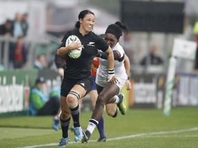 New Zealand's Carla Hohepa, left, runs with the ball during the Women's Rugby World Cup semifinal match against the United States in Belfast, Northern Ireland, Tuesday Aug. 22, 2017. (AP Photo/Peter Morrison)