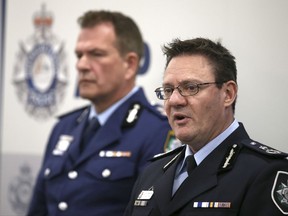 Australian Federal Police Deputy Commissioner Michael Phelan, right, and New South Wales state Police Deputy Commissioner David Hudson discuss details of the charging of two men with terrorism offenses in Sydney, Friday, Aug. 4, 2017. The men, ages 49 and 32, were each charged with two counts of planning a terrorist act in connection with an alleged plot to bring down an airplane, police said. (AP Photo/Rick Rycroft)