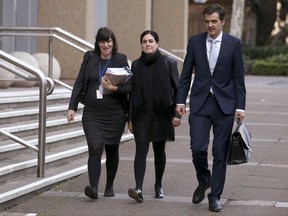 Jonathon Hunyor, right, CEO of the Public Interest Advocacy Centre arrives the law courts with solicitors Laura Lombardo and Camilla Pandolfini, left, in Sydney, Thursday, Aug. 10, 2017, to lodge an application in the High Court for an injunction to prevent a vote on gay marriage through a non-binding ballot by mail. The so-called postal plebiscite has never been tried in Australia and faces court challenges by gay-rights advocates who want Parliament to legislate marriage equality now without an opinion poll. (AP Photo/Rick Rycroft)
