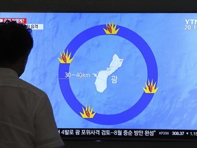 In this Aug. 10, 2017, file photo, a man watches a TV screen showing a local news program reporting on North Korea's threats to strike Guam with ballistic missiles, at the Seoul Train Station in Seoul, South Korea. If, after all the fanfare, North Korean leader Kim Jong Un doesn't actually launch missiles toward Guam, many may write the whole episode off as another of the North's seemingly endless bluffs. But from Pyongyang's perspective and in the eyes of some U.S. military experts, Kim and his generals have already won this round. (AP Photo/Ahn Young-Joon, File)