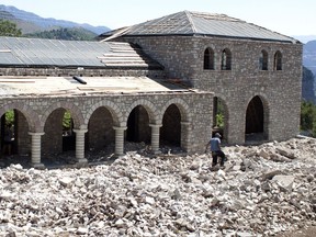 In this Tuesday, July 18, 2017, workers build a guest house in the village of Nivica, southern Albania. An ambitious project is aiming to open up remote villages in the highlands of southern Albania to the outside world and to tourists wanting to discover the spectacular natural beauty and rural way of life of the more isolated parts of the Balkan country. (AP Photo/Geo Delveroudis)