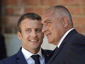 French President Emmanuel Macron hugs Bulgarian Prime Minister, Bojko Borisov, right, at the Euxinograd residence outside Varna, Bulgaria, Friday, Aug. 25, 2017. Macron arrived Friday at a French-style palace on the Black Sea coast for talks with Bulgarian leaders on the final leg of his three-day tour to central and eastern Europe. (AP Photo/Vadim Ghirda)