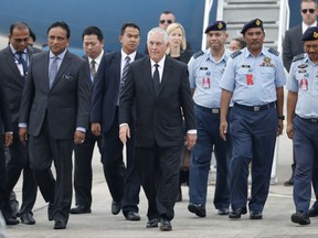 U.S. Secretary of State Rex Tillerson, center, arrives at a military base in Subang, Malaysia, Tuesday, Aug. 8, 2017. (AP Photo/Vincent Thian)