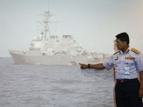 Malaysian Maritime Director Indera Abu Bakar points the damage of USS John S. McCain shown on a screen during a press conference in Putrajaya, Malaysia, Monday, Aug. 21, 2017. The U.S. Navy said the USS John S. McCain arrived at Singapore's naval base with "significant damage" to its hull after a collision early Monday between it and an oil tanker east of Singapore. A number of U.S. sailors are missing after the collision, the second accident involving a ship from the Navy's 7th Fleet in the Pacific in two months. (AP Photo/Daniel Chan)
