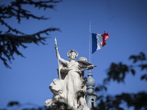 A French flag flies at half-staff for the victims of the Spain attacks on the Grand Palais in Paris, Saturday, Aug. 19, 2017. Police on Friday shot and killed five people carrying bomb belts who were connected to the Barcelona van attack, as the manhunt intensified for the perpetrators of Europe's latest rampage claimed by the Islamic State group. (AP Photo/Kamil Zihnioglu)