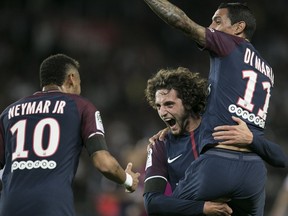 PSG's Adrien Rabiot, center, PSG's Angel Di Maria smile to PSG's Neymar, left, after scoring during the French League One soccer match between PSG and Toulouse at the Parc des Princes stadium in Paris, France, Sunday, Aug. 20, 2017. (AP Photo/Kamil Zihnioglu)
