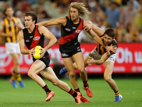 Essendon Bombers captain Dyson Heppell (centre) watches Andrew McGrath break upfield in an Australian Football League match against the Hawthorn Hawks on March 25.