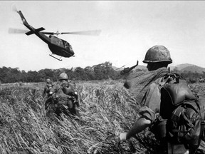 American soldiers of the 173th airborne are evacuated by helicopter from a Vietcong position 11 December 1965.