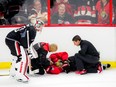In this Sept. 25, 2016 file photo, Clarke MacArthur lies injured on the ice after taking a high hit at Ottawa Senators training camp.