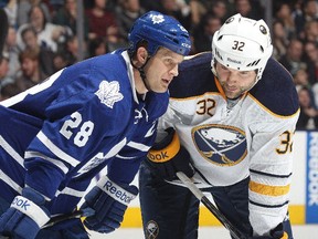 Colton Orr, left, chats with fellow enforcer John Scott during an NHL game at the Air Canada Centre on Dec. 27, 2013.