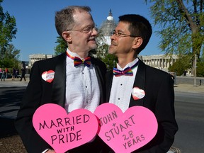 A gay couple, John and Stuart from California, married from 28 years, pose outside the US Supreme Court waiting for its decision on April 28, 2014 in Washington, DC.