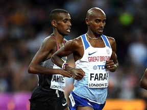 Canadian Mohammed Ahmed runs with Mohamed Farah of Great Britain during the men's 5,000 metres final at the 16th IAAF World Athletics Championships in London on Aug. 12, 2017.