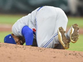 Toronto Blue Jays pitcher Marcus Stroman of the Toronto Blue Jays grimaces in paid after getting hit by a line drive by  the Orioles' Mark Trumbo during their game Saturday night in Baltimore.