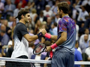Juan Martin del Potro, right, shakes hands with Roger Federer after their men's quarter-final match at the U.S. Open in New York on Wednesday night. Del Potro advanced with a win in four sets.