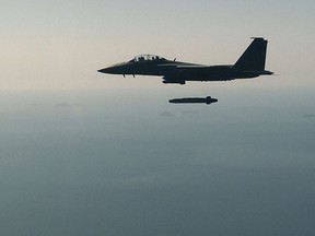 South Korean Air Force F-15K fighter jet flying with a Taurus long-range air-to-surface missile during an exercise on September 12, 2017 in Taean-gun, South Korea