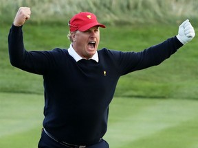Charley Hoffman of the U.S. team celebrates after chipping in on the 17th hole during Saturday four-ball matches of the Presidents Cup at Liberty National Golf Club in Jersey City, N.J.