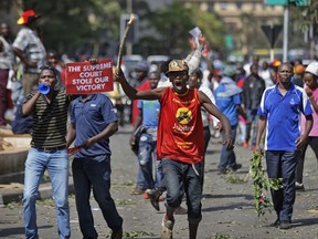 Supporters of President Uhuru Kenyatta, angry at the Supreme Court's nullification earlier this month of the August presidential election, protest outside the court in downtown Nairobi, Kenya Tuesday, Sept. 19, 2017. The court invalidated the election in a summary judgement on Sept. 1 and ordered a new election, but announced Tuesday that it will deliver its detailed ruling on Wednesday. (AP Photo/Ben Curtis)