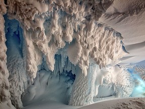 This undated hand out picture released by the Australian National University on September 8, 2017 and taken by Joel Bensing shows inside view of an ice cave on the Erebus Glacier tongue, Ross Land, Antartica near McMurdo Station and Scott Base.  A secret world of animals and plants may live in warm caves under Antarctica's glaciers, including new species, scientists said on September 8, 2017.