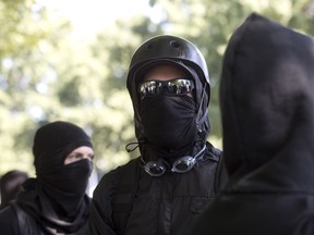Antifa protesters wear bandanas over their face during a protest to oppose the right wing group "The Patriot Prayer Movement," that was having a rally in downtown Portland, Oregon on September 10, 2017