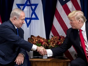 Israel's Prime Minister Benjamin Netanyahu (L) and US President Donald Trump shake hands before a meeting at the Palace Hotel during the 72nd session of the United Nations General Assembly on September 18, 2017, in New York.