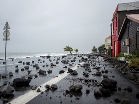 A picture shows rocks swept by strong waves onto a road in Le Carbet, on the French Caribbean island of Martinique, after it was hit by Hurricane Maria, on September 19, 2017