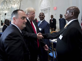 US President Donald Trump (C) greets Uganda's President Yowri Kaguta Museveni (R) before a luncheon with US and African leaders at the Palace Hotel during the 72nd United Nations General Assembly on September 20, 2017 in New York.