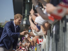 Britain's Prince Harry greets a waiting crowd as he visits The Centre for Addiction and Mental Health in Toronto on September 23, 2017.