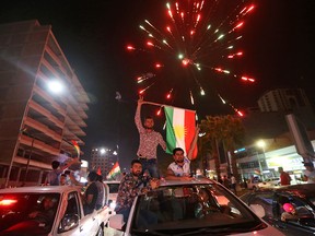 Iraqi Kurds wave the Kurdish flag as they celebrate in the streets of the northern city of Arbil on September 25, 2017 following a referendum on independence.