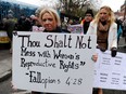 A protester displays a banner against Ireland's abortion laws during a march against Government austerity measures in Dublin, Ireland.