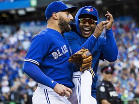 Toronto Blue Jays centre fielder Kevin Pillar, left, is congratulated by teammate Marcus Stroman after making an inning-ending catch in fifth inning Saturday.