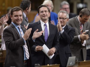 Conservative MP and finance critic Pierre Poilievre is applauded by fellow MPs during question period in the House of Commons on Parliament Hill in Ottawa on Wednesday, Sept.27, 2017.