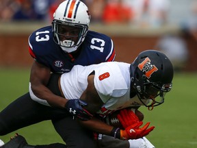 Mercer wide receiver Marquise Irvin (8) catches a pass as Auburn defensive back Javaris Davis (13) tackles him during the first half of an NCAA college football game, Saturday, Sept. 16, 2017, in Auburn, Ala. (AP Photo/Butch Dill)