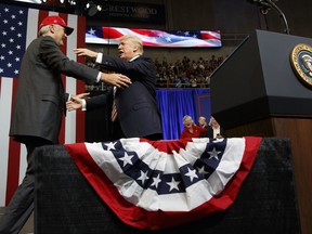 President Donald Trump hugs U.S. Senate candidate Luther Strange during a campaign rally, Friday, Sept. 22, 2017, in Huntsville, Ala. (AP Photo/Evan Vucci)