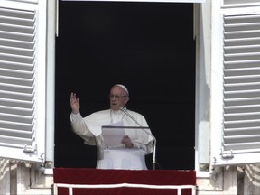 Pope Francis delivers his blessing during the Angelus noon prayer from the window of his studio overlooking St. Peter's Square, at the Vatican, Sunday, Sept. 24, 2017. (AP Photo/Alessandra Tarantino)